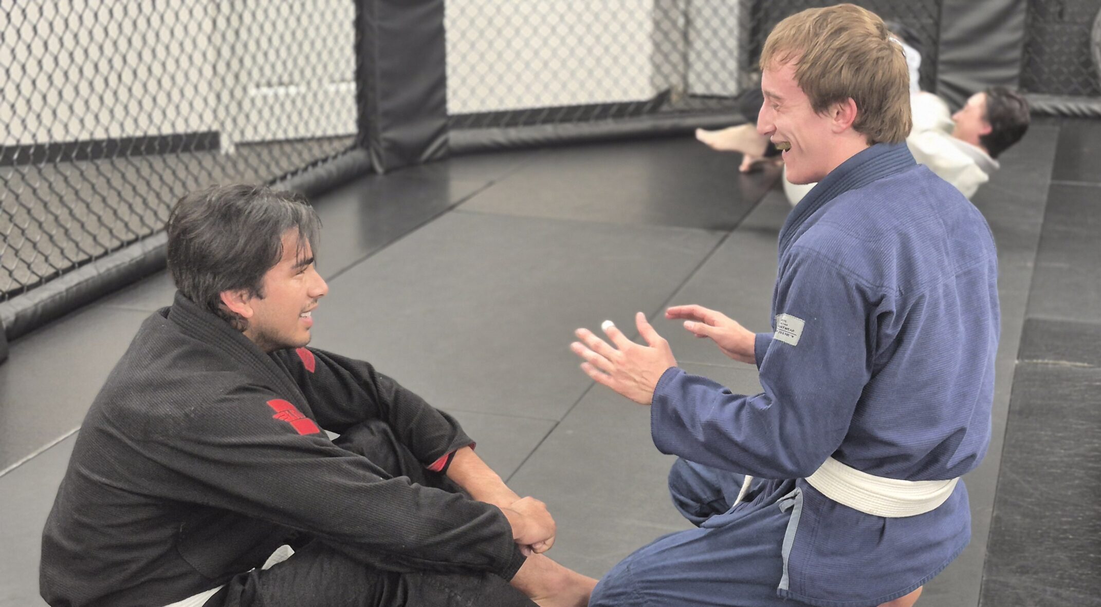 Adult Beginner BJJ Training at Deep Water BJJ in Harrisburg Two adult Brazilian Jiu-Jitsu students talking during training at Deep Water BJJ in Harrisburg, PA.