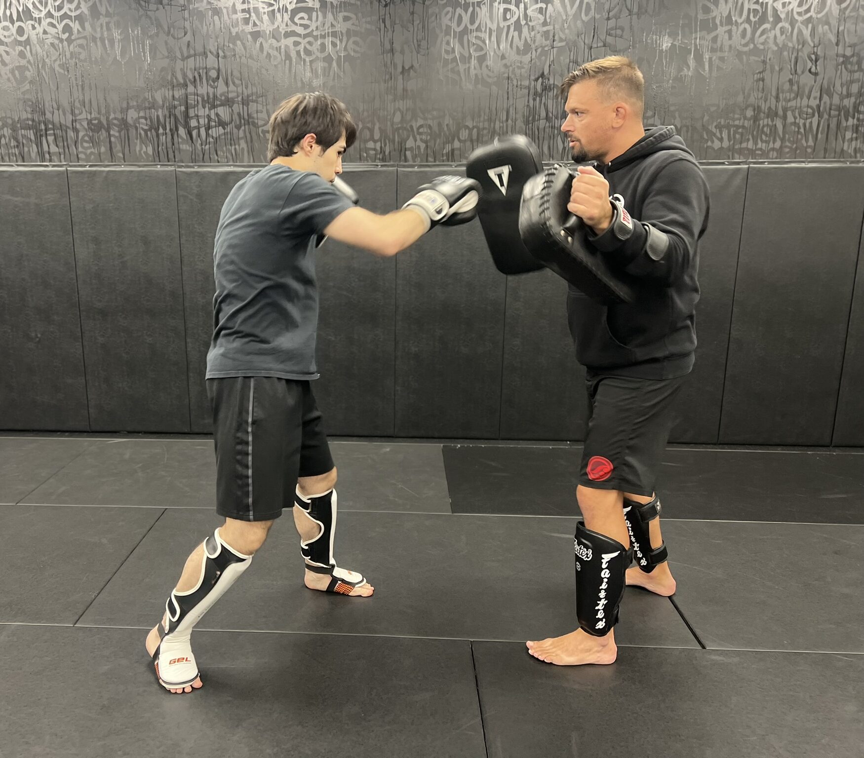 Striking Training at Deep Water BJJ in Harrisburg Adult student practicing punches with a coach during striking training at Deep Water BJJ in Harrisburg