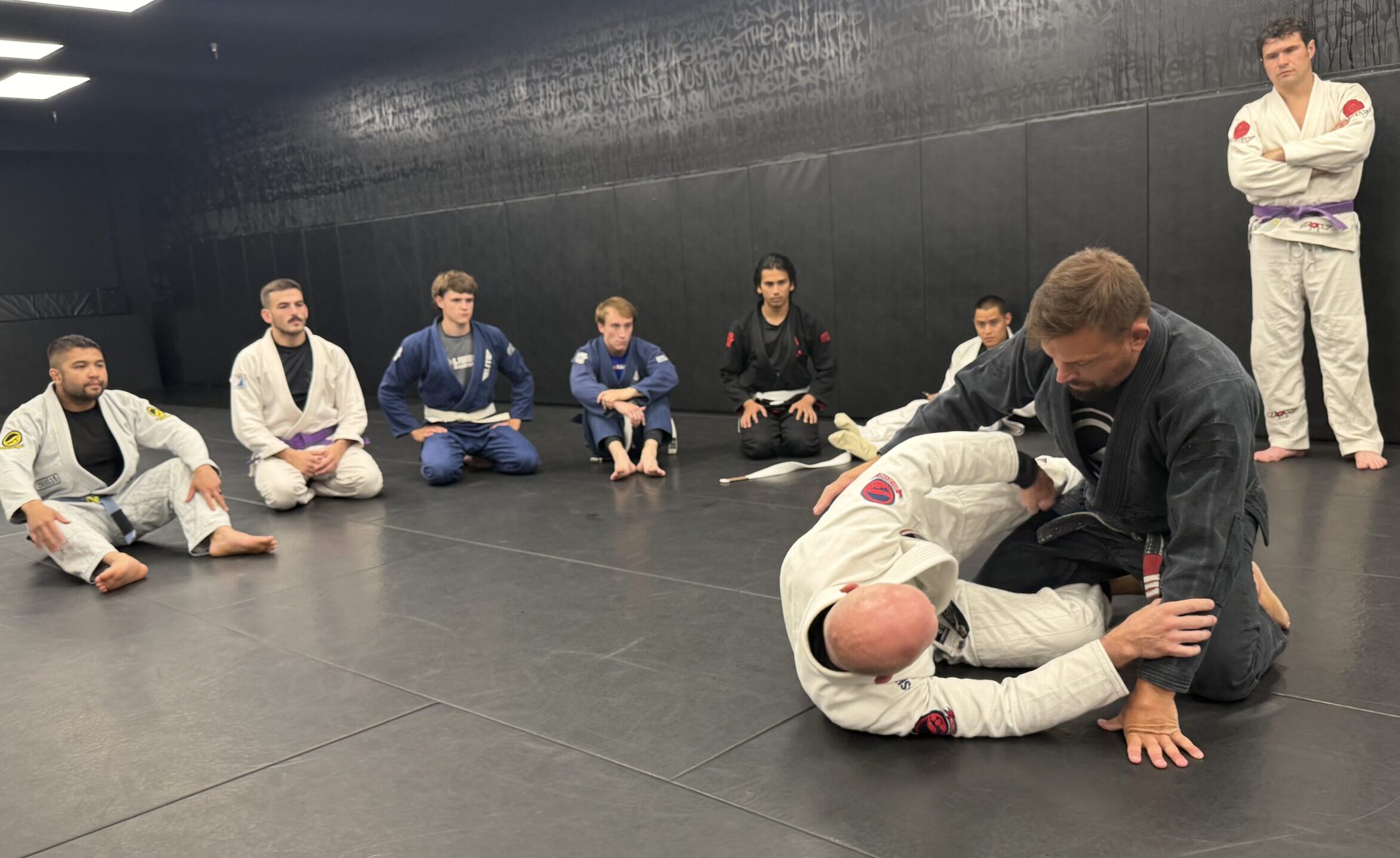 Adult Brazilian Jiu-Jitsu Instruction at Deep Water BJJ Brazilian Jiu-Jitsu coach demonstrating a technique to adult students at Deep Water BJJ in Harrisburg