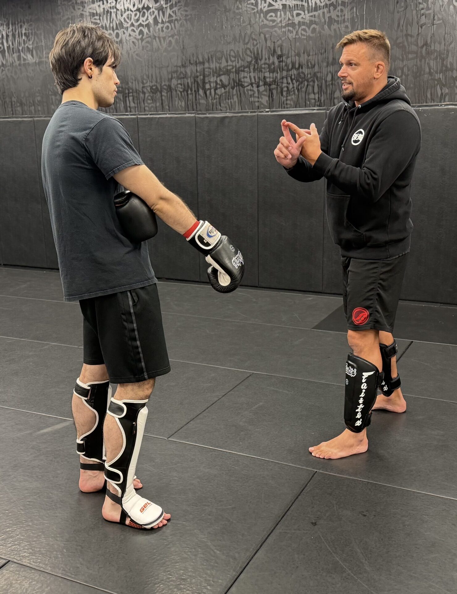 Coach instructing an adult student during Striking Intro at Deep Water BJJ in Harrisburg