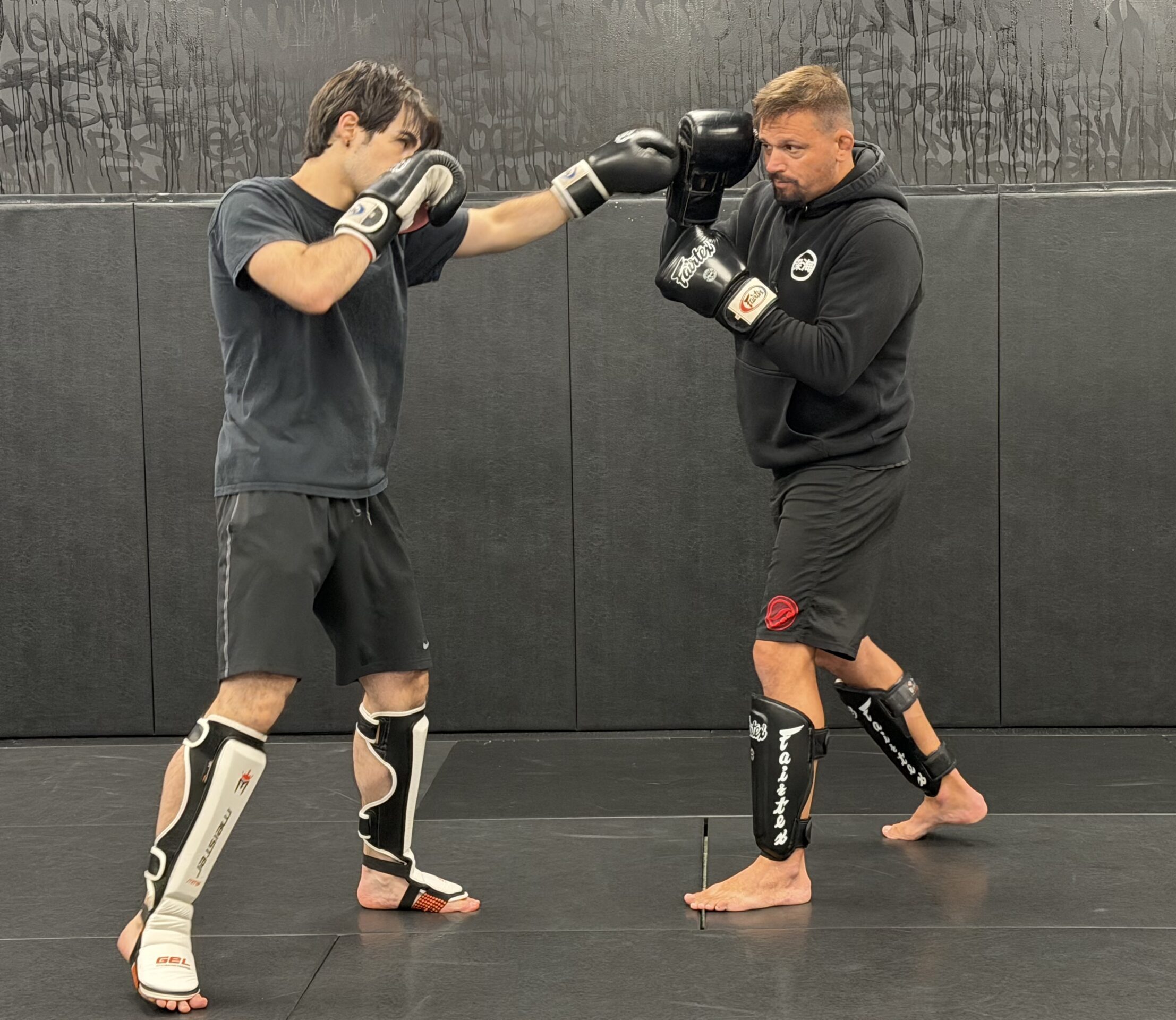 Adult student practicing striking with a coach during CAP Striking at Deep Water BJJ in Harrisburg