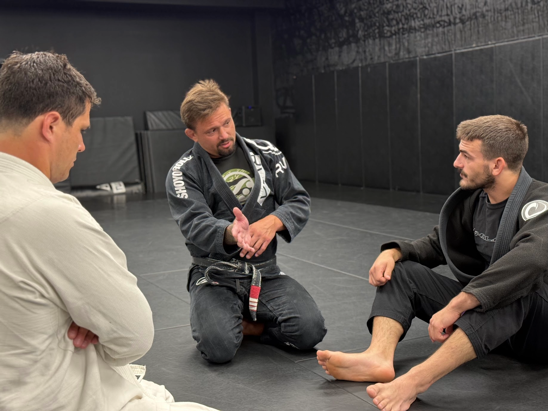 Deep Water BJJ instructor giving students individual feedback during Brazilian Jiu-Jitsu class.