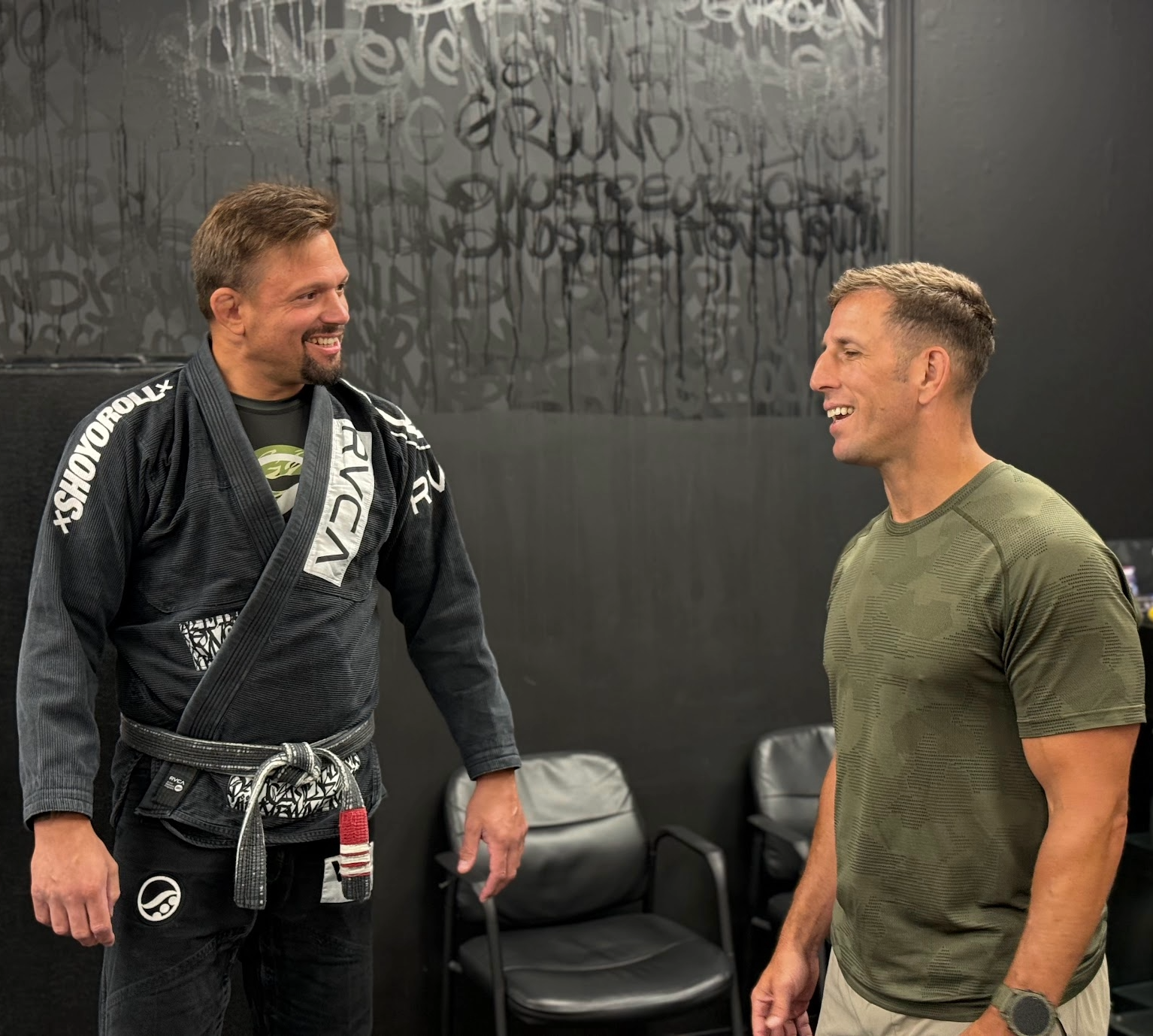 Deep Water BJJ instructor talking with a visitor inside the Harrisburg martial arts academy.